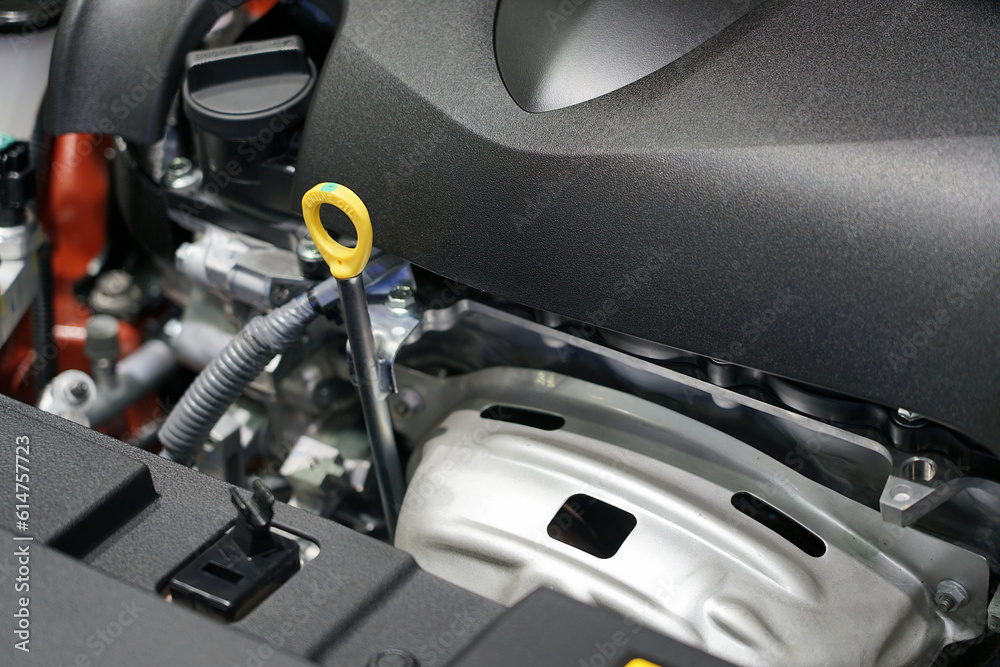 Oil level dipstick located inside the engine compartment of the car