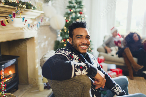 Portrait smiling man enjoying Christmas in living room