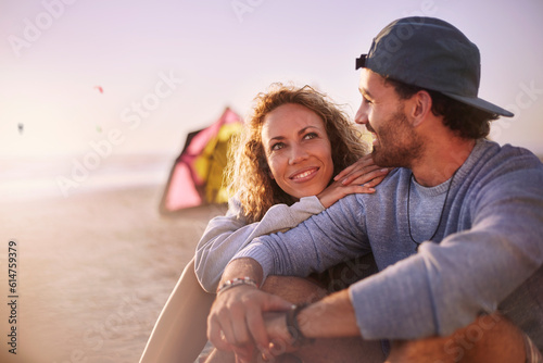 Couple sitting and talking on beach