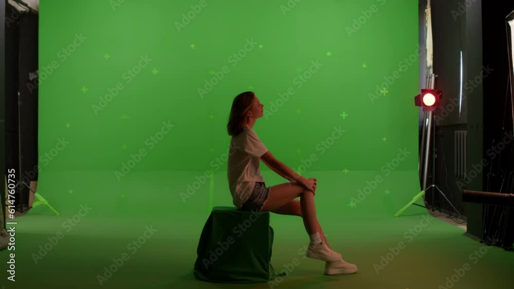 Silhouette young caucasian woman sitting on the top of a mountain or roof watching the sunset with beautiful landscape on Green screen background, chroma key. Silhouette young caucasian woman sitting on the top of a mountain or roof watching the sunset with beautiful landscape on Green screen background, chroma key.