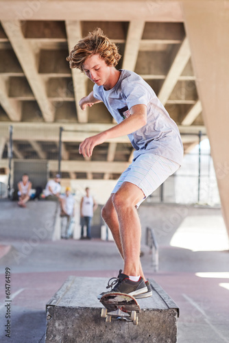 Teenage boy skateboarding at skate park