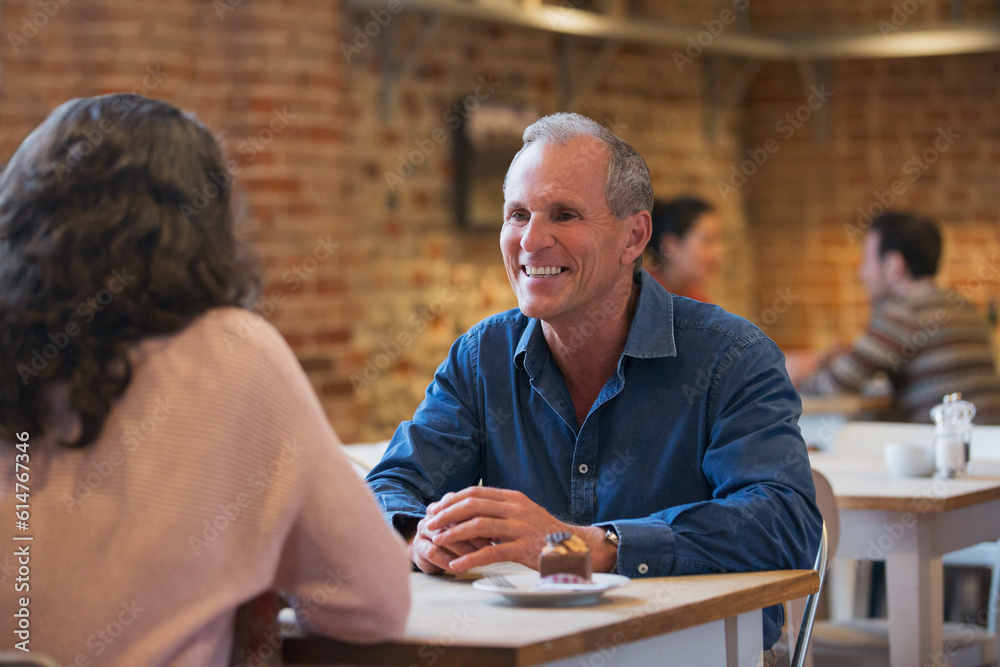 Smiling couple talking in cafe Smiling couple talking in cafe