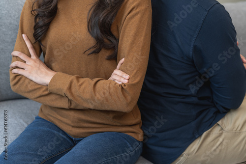 Family problem concept, Asian wife and husband sitting back to back in the living room at home have problems in a relationship and have an argument