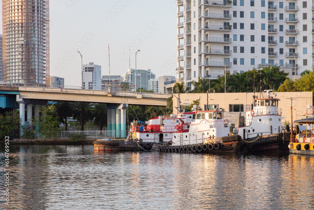 Tug boats at river side in Miami River Drive area