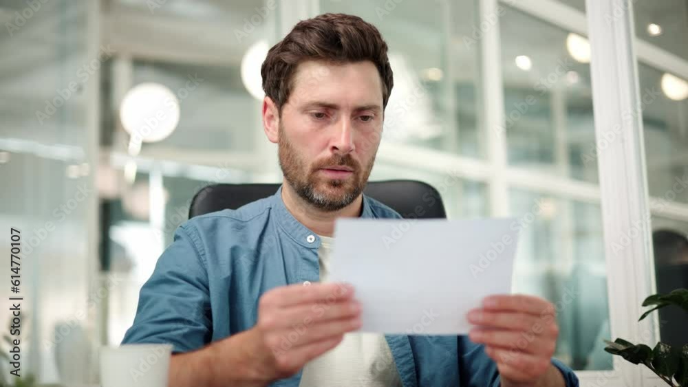 Angry stressed businessman opening envelope reading bad terrible news in mail letter. Mad man feels frustrated about high bills, dismissal notice, bank debt, tax invoice, mistake sits at office desk. Angry stressed businessman opening envelope reading bad terrible news in mail letter. Mad man feels frustrated about high bills, dismissal notice, bank debt, tax invoice, mistake sits at office desk.