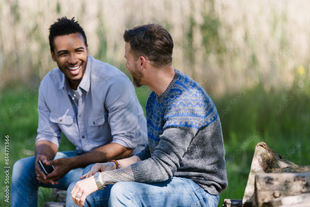 Smiling men talking outdoors