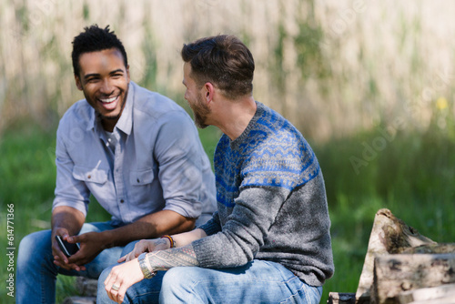 Tableau sur toile Smiling men talking outdoors
