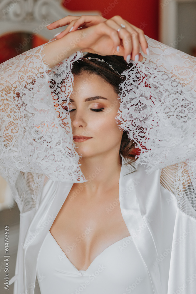 the bride in an open robe, open bust. Great hairstyle. lace robe, close-up portrait, looking into the camera the bride in an open robe, open bust. Great hairstyle. lace robe, close-up portrait, looking into the camera