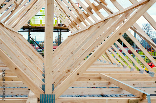New residential home construction with roof framing joist against a sky