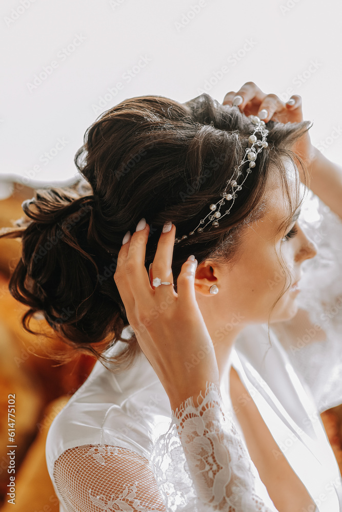 Portrait of a beautiful girl in a wedding dress. Preparation of the bride for the wedding ceremony, morning dressing close-up