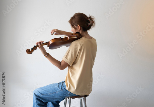 Woman holding violin and bow in hand,prepare for practice,