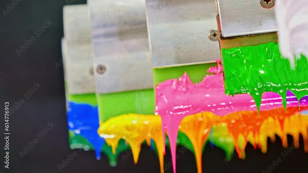 Colorful plastisol ink sticks are stretched on the printer handle ...