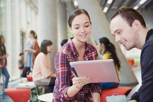 College students using digital tablet in commons