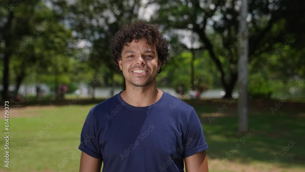 Close up portrait of attractive mixed race man smiling at the park on a sunny day
Close up portrait of attractive mixed race man smiling at the park on a sunny day
