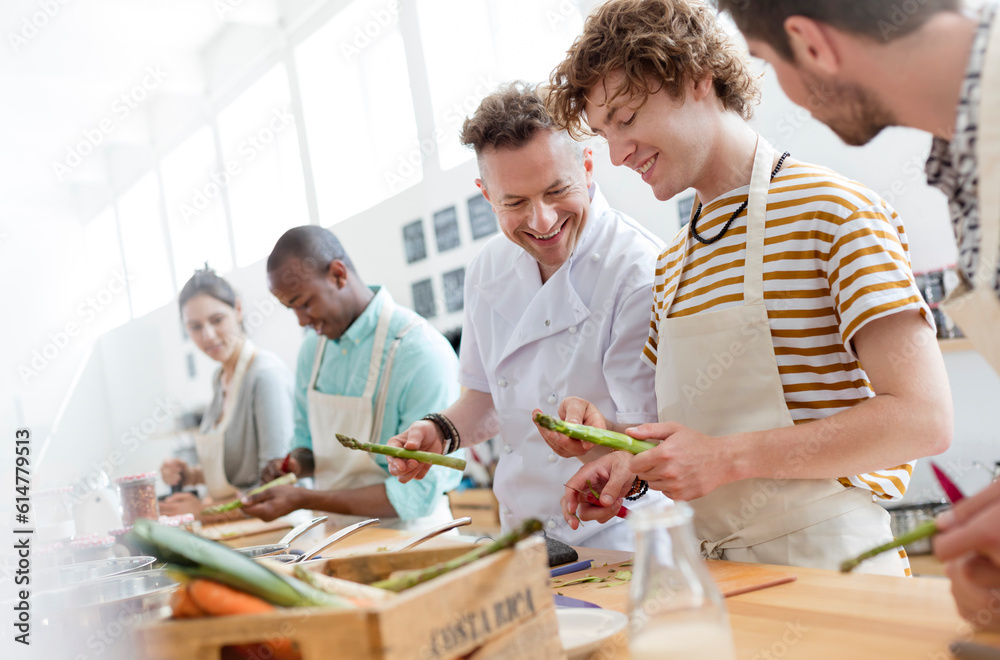 Chef teacher and students in cooking class kitchen Chef teacher and students in cooking class kitchen