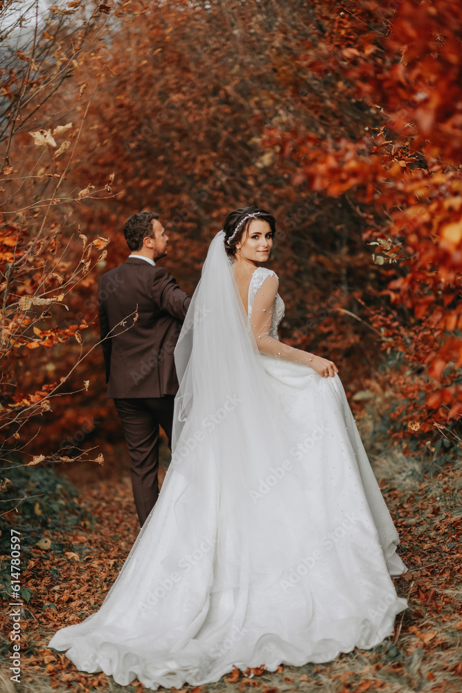 Wedding couple on a walk in the autumn park, medium portrait, place for text