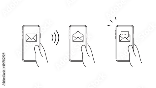 手に持ったスマートフォンにメールのアイコンのセット