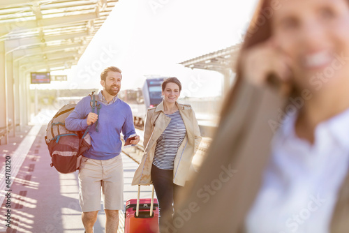 Couple with luggage at train station