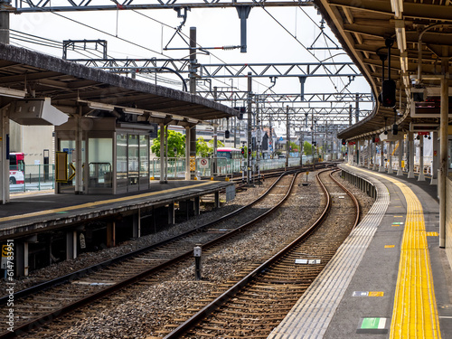 Japanese train station. Serene and still, the empty Japanese train station exudes a tranquil ambiance, with platforms awaiting the rush of passengers and echoes of past journeys lingering in the air. photo