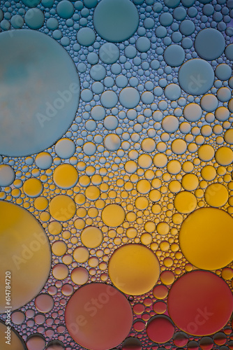 multi colored oil circles on the water, colorful background