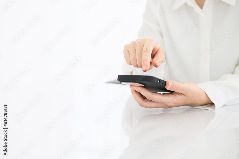 businesswoman using smart phone in office, hand close up businesswoman using smart phone in office, hand close up