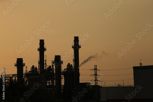 Power plant against orange light sunset with clean energy concept.