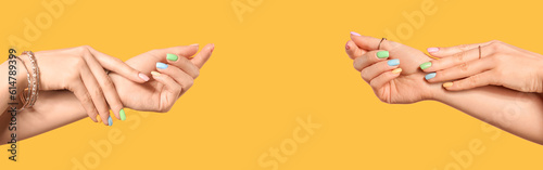 Hands of young woman with beautiful manicure on color background