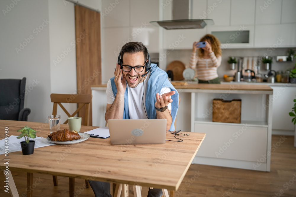 One man caucasian male freelancer work from home on laptop computer One man caucasian male freelancer work from home on laptop computer