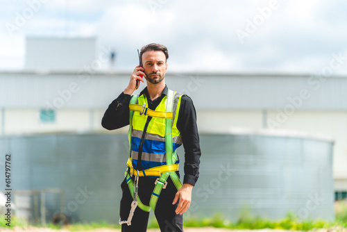 Elegant engineer holding a walkie talkies to working in determined and has a vision like a leader, Discussion and coordination between departments about problem solving, blue collar concept