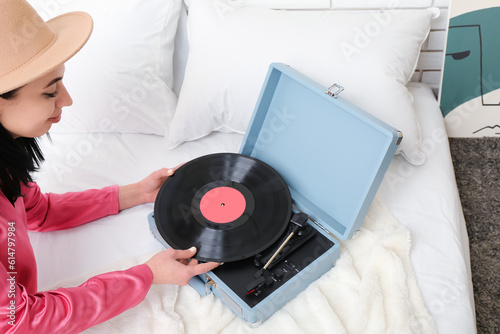 Young woman with vinyl disk...