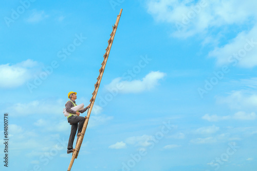 Asian business man engineer climbing up llong adder with blue sky, career growth and success concept photo