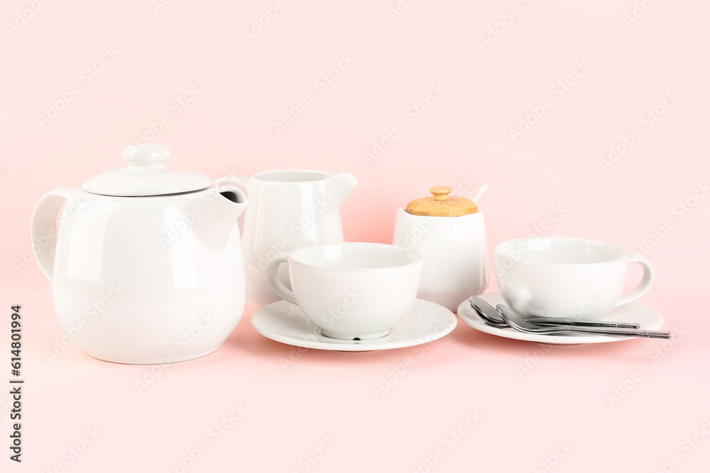 Stylish tea set on pink background Stylish tea set on pink background