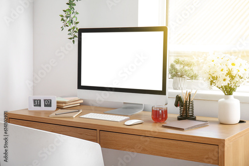 Modern workplace with computer and stationery in office © Pixel-Shot