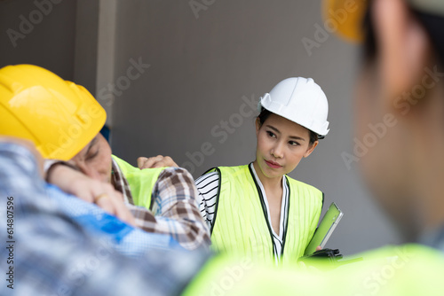 Foreman user radio to nurse for first aid Construction worker faint in construction site because Heat Stroke. Worker with safety helmet take a nap because so are tired from working in the hot sun