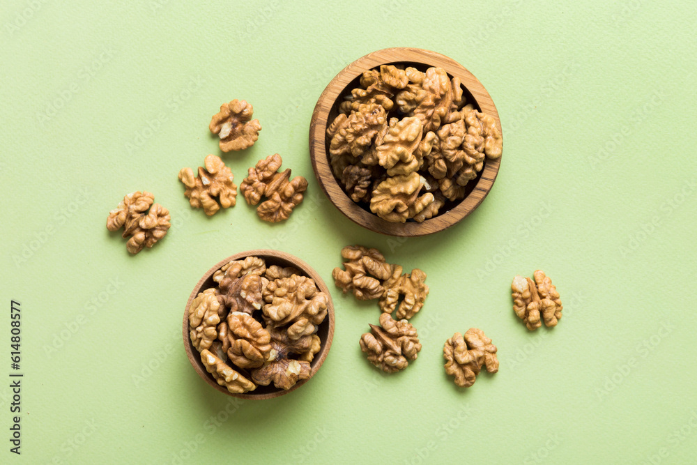 Fresh healthy walnuts in bowl on colored table background. Top view Healthy eating bertholletia concept. Super foods Fresh healthy walnuts in bowl on colored table background. Top view Healthy eating bertholletia concept. Super foods