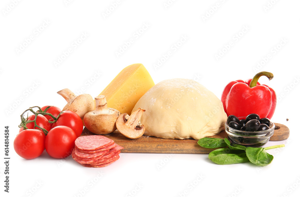 Wooden board with raw dough and ingredients for preparing pizza on white background Wooden board with raw dough and ingredients for preparing pizza on white background