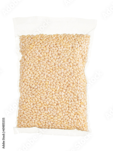 Grains of peeled pine nuts in a vacuum package on a white background. Advertising photo for an online store or trading platform.
