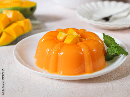 Mango pudding, jelly, dessert on white plate. Close up.