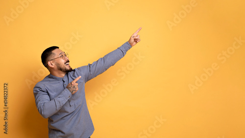 Great Offer. Cheerful Young Asian Man Indicating Copy Space With Two Hands