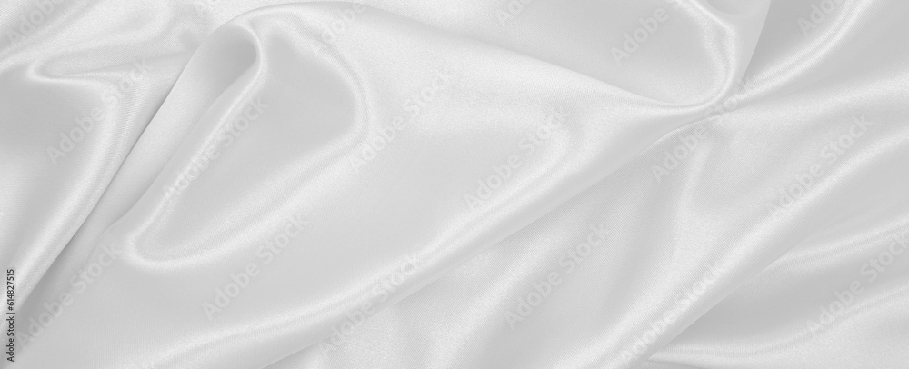 Smooth elegant white silk or satin luxury cloth texture as wedding background. Luxurious Christmas background or New Year background design