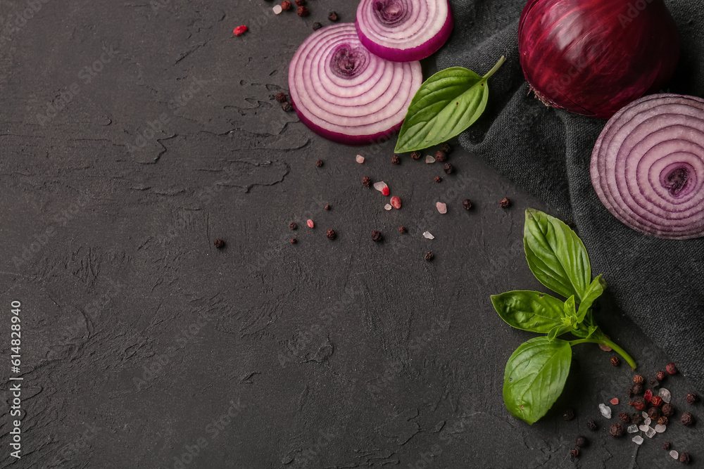 Fresh onion and spices on dark background