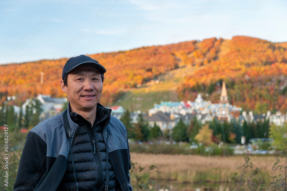 Tourist posing for photos in front of Mont Tremblant village in Autumn, Quebec, Canada. Tourist posing for photos in front of Mont Tremblant village in Autumn, Quebec, Canada.