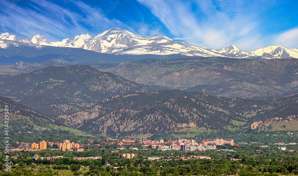 The city of Boulder, Colorado, lies at the base of the Rocky Mountain foothills, with the Continental Divide in the background.