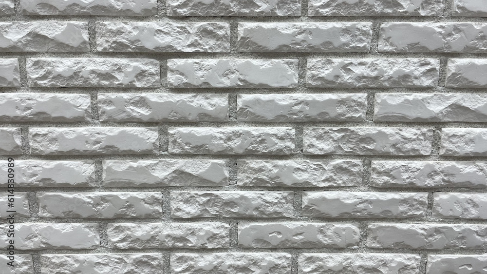 Fototapeta premium The background of an old vintage dirty brick wall with peeling plaster, texture for games, high-quality photos of bricks and walls, smooth seams and building material, the builder puts the wall