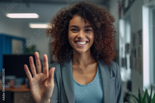 Close up of a woman at work smiling at her workplace and giving a high five to the camera. Generative AI