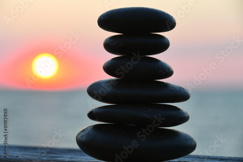 Relaxation Zen concept - cairn  stacked stones outside  blurred sunset sun nature background
