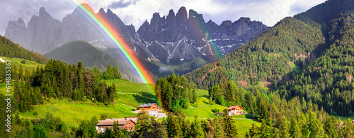 Majestic Dolomites rocks - most beautiful mountains in Alps, UNESCO site. Unique shoot with rainbow. Beautiful valley Val di Funes in South Tyrol, Italy