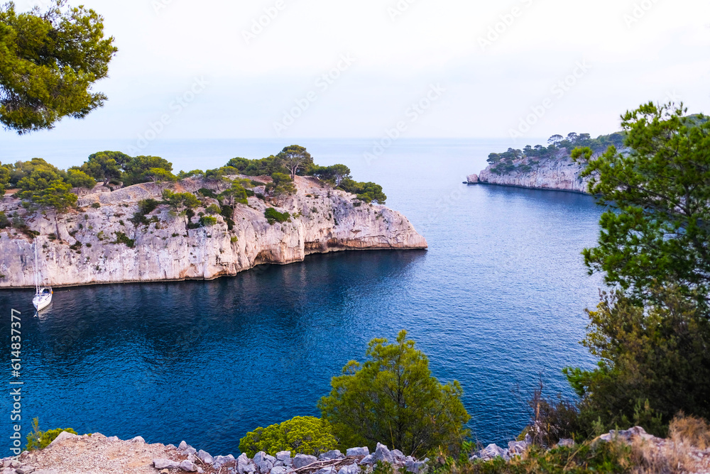 Beautiful seascape with smooth water surface and rocky cliffs in Calanques National Park. Popular travel destination in Southern France.