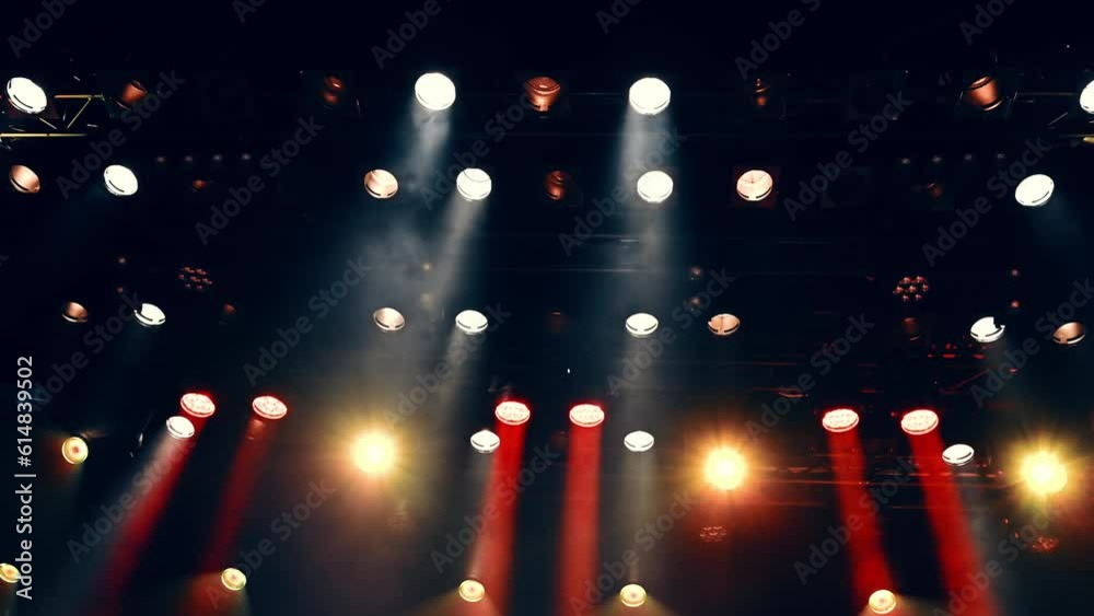 Atmosferic stage light from spotlights flashing during the concert or show