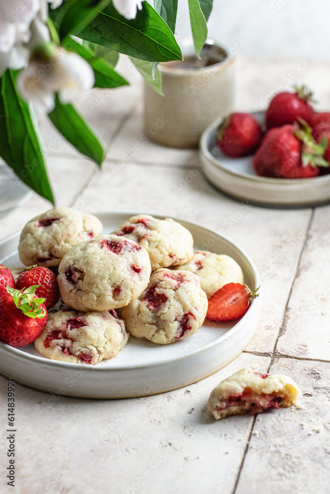 Homemade cookies with strawberries. Delicious summer pastries on pink tile background